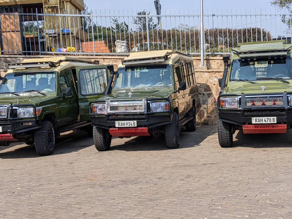 4x4 Toyota Land Cruiser safari vehicle for hire in Rwanda parked on a brick driveway near green trees